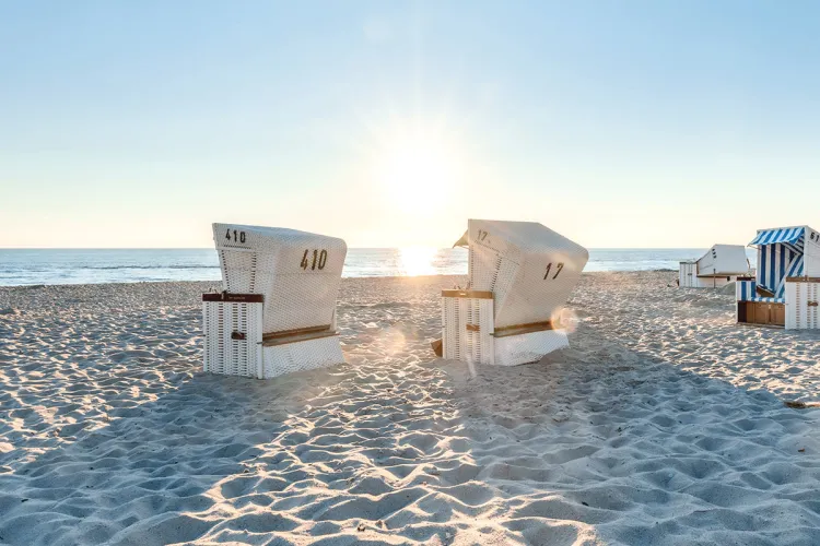 Summer beach chairs on the sandy beach in front of Grand Hotel Binz with sea view