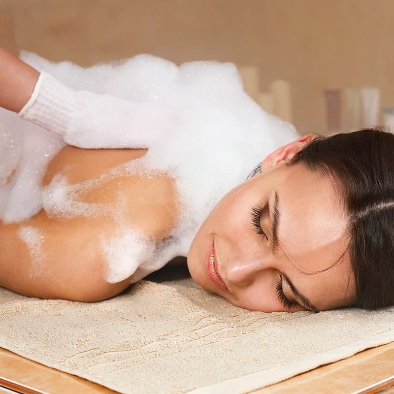 Oriental body cleansing with foam, special glove and peeling on the warm stone bench in the hammam.